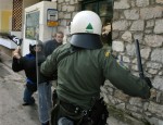 Police clash with protesters during a rally in the town of Amfissa, about 200 kilometers (125 miles) northwest of Athens on Wednesday, Jan. 20, 2010. A court in the small town of Amfissa postponed until Friday the trial of two policemen over a teenager's fatal shooting that sparked riots across Greece in December 2008. Minor clashes broke out when police fired tear gas at a group of some 200 mostly anarchist protesters who marched from the court house to a prison complex just outside Amfissa.