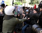 Police clash with protesters during a rally in the town of Amfissa, about 200 kilometers (125 miles) northwest of Athens on Wednesday, Jan. 20, 2010. A court in the small town of Amfissa postponed until Friday the trial of two policemen over a teenager's fatal shooting that sparked riots across Greece in December 2008. Minor clashes broke out when police fired tear gas at a group of some 200 mostly anarchist protesters who marched from the court house to a prison complex just outside Amfissa.