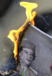 burning picture of Libyan leader Muammar Gaddafi